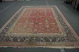 A good large Persian design carpet, rust ground with floral decoration, 440cm x 310cm.
