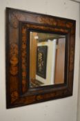 A good 18th century floral marquetry inlaid walnut cushion shaped wall mirror.