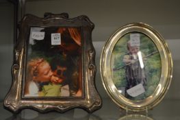 Two silver photograph frames.