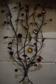 Wrought iron wall art modelled as a spray of flowers.