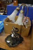 Combination table lamp and water feature decorated with dolphins.