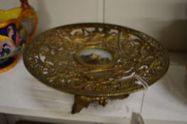 An ormolu comport inset with a painting of a ruin.