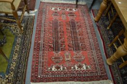A Persian rug, red ground with stylised decoration, 180cm x 110cm.