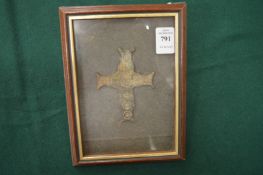 A bronze cross, framed and glazed.