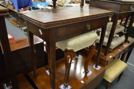 A 19th century oak fold-over tea table with a single frieze drawer.