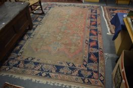 Persian rug, pink ground with stylised decoration, worn, 295cm x 186cm.