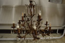 A decorative naturalistic style metal and crystal drop two-tier twelve light chandelier.