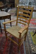 A good set of ten oak and rush seated ladderback dining chairs, two with arms.