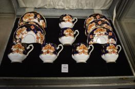 A cased set of six Royal Albert Heirloom pattern coffee cups and saucers (lacking spoons).