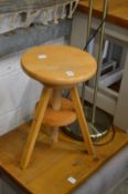 An adjustable revolving stool and a modern floor standing lamp.