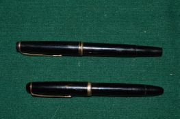 Two Mont Blanc fountain pens.