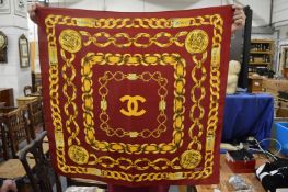 A Chanel gold chain decorated silk scarf.