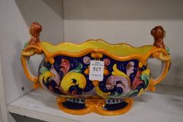 An Italian maiolica bowl with figural handles.