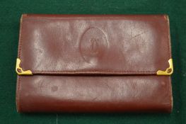 A Cartier leather purse.