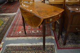 A good George III mahogany Pembroke table with cross banded decoration on tapering reeded supports.