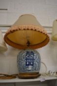 A Chinese blue and white jar mounted as a lamp.