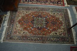 A Persian rug, rust ground with floral decoration, 162cm x 103cm.