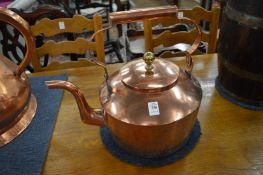 A large copper kettle.
