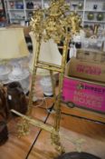 A pair of ornate brass easels.