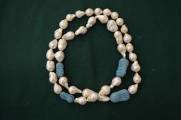 A pearl and turquoise necklace.