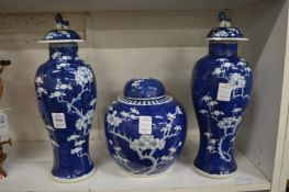 A pair of Chinese blue and white prunus pattern jars together with a similar ginger jar and cover (