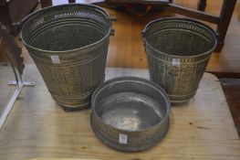 An Eastern metal jardiniere and similar buckets.