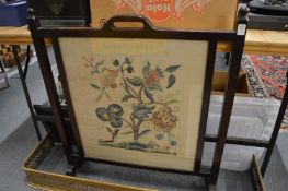 A fire screen with embroidered panel.