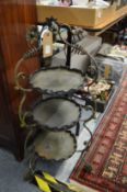 A wrought iron three tier stand.