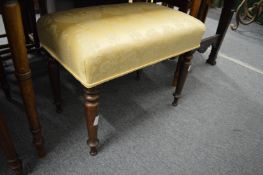A 19th century upholstered stool on turned legs.