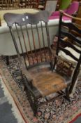 A 19th century stick back rocking chair with traces of painted decoration.