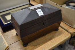 A rosewood tea caddy.