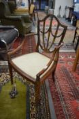 A Sheraton Revival painted mahogany shield back armchair.