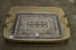 An unusual tray decorated with numerous shells.