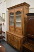 An 18th/19th century French oak cabinet, the upper section with pair of wire mesh glazed doors above