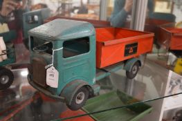 A Tri-ang red and green tip-up transporter truck.