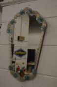 A small Venetian style wall mirror.