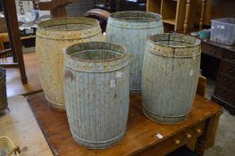 Two pairs of distressed painted barrel shaped metal storage containers.