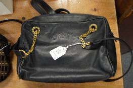 A Paloma Picasso black leather bag.