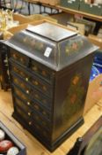 A lacquer jewellery casket with hinged top and five drawers.