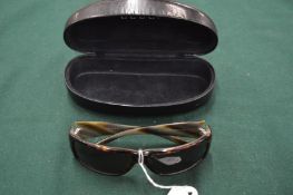 A pair of Gucci sunglasses, cased.