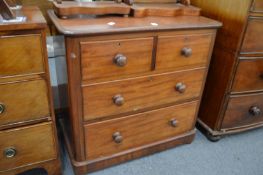 A Victorian mahogany small chest of two short and two long drawers.
