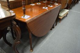 A mahogany oval drop-leaf gateleg table dining table.