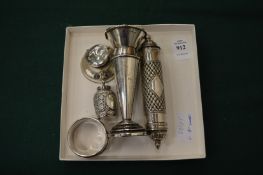 A group of small silver items.