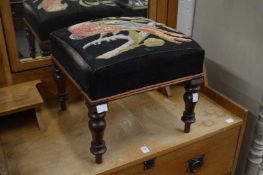 An upholstered foot stool.