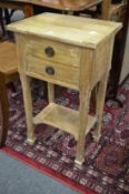 A pair of Continental limed wood two drawer bedside tables with undertier.