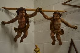 A good pair of early carved and painted cherubs.