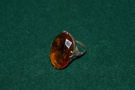 A silver and amber ring.