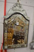 A small Venetian style dressing table or wall mirror.