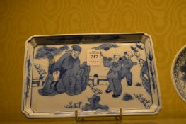 Chinese blue and white tray decorated with figures, a small circular dish and another tray.