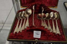 A cased set of eight silver plated teaspoons with matching sugar tongs.